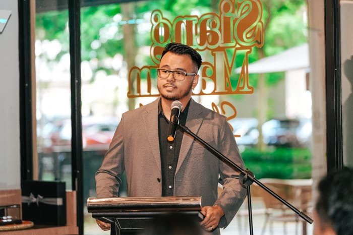 CEO Uzair Haqimy at the podium