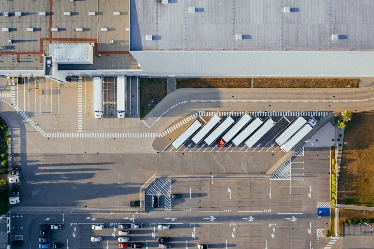 Trucks lined up at a distribution centre loading dock, seen from above